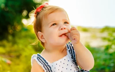Toddler sucking thumb outdoors, illustrating thumb sucking habit and its effects on children's dental health.