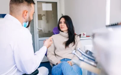 Dentist consulting with a patient in a dental office, discussing tooth extraction and oral health.