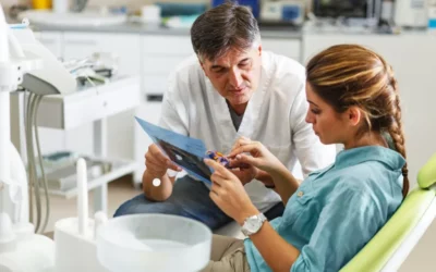 Dentist discussing dental care options with patient in a dental office setting.